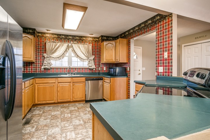 391 Oakley Allons Road Allons, TN 38541 - Photo 9 of 35 a kitchen with sink a window and cabinets