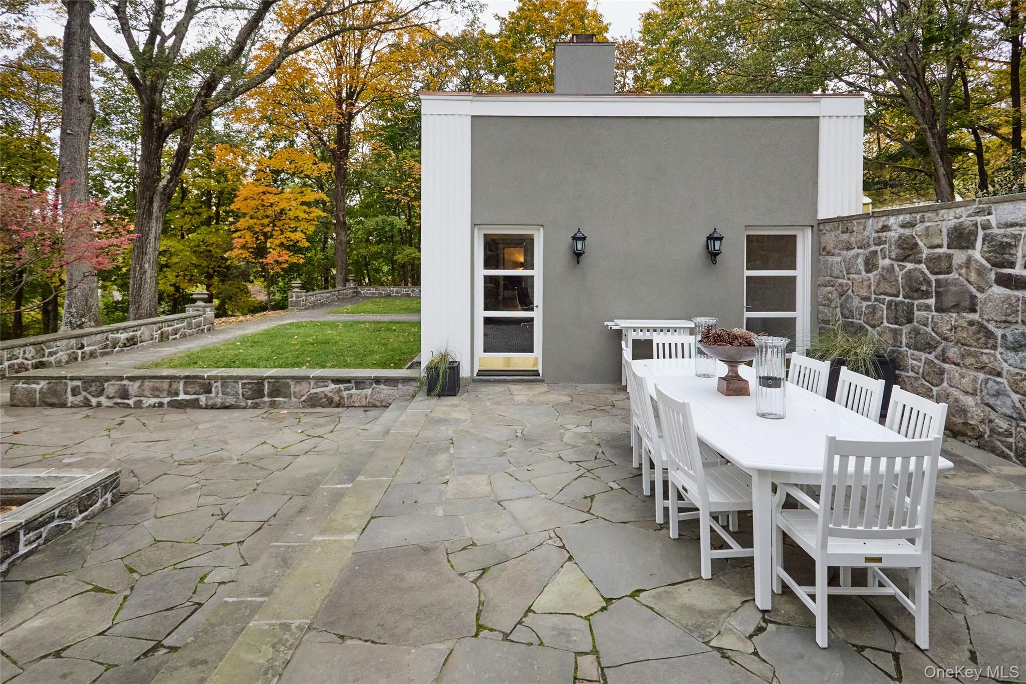 72 Lookout Road Tuxedo Park, NY 10987 - Photo 19 of 49 a view of a patio with table and chairs with wooden fence and plants
