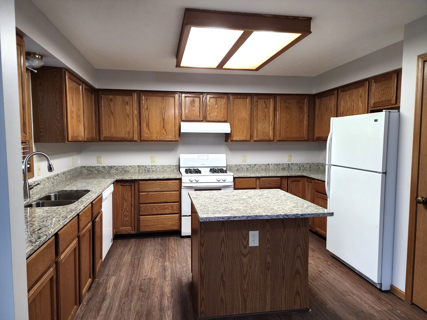 240 Mitchell Court Braidwood, IL 60408 - Photo 6 of 18 a kitchen with granite countertop a sink stove and refrigerator