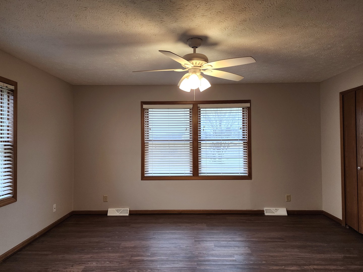 240 Mitchell Court Braidwood, IL 60408 - Photo 7 of 18 a view of an empty room with wooden floor and a window