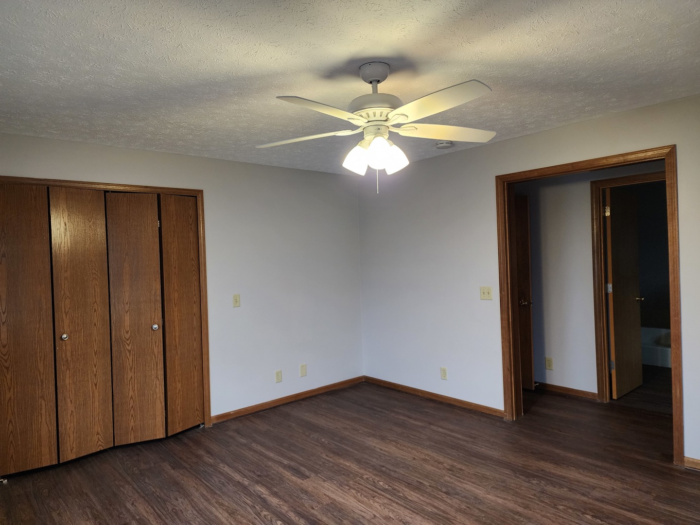 240 Mitchell Court Braidwood, IL 60408 - Photo 8 of 18 an empty room with wooden floor fan and windows