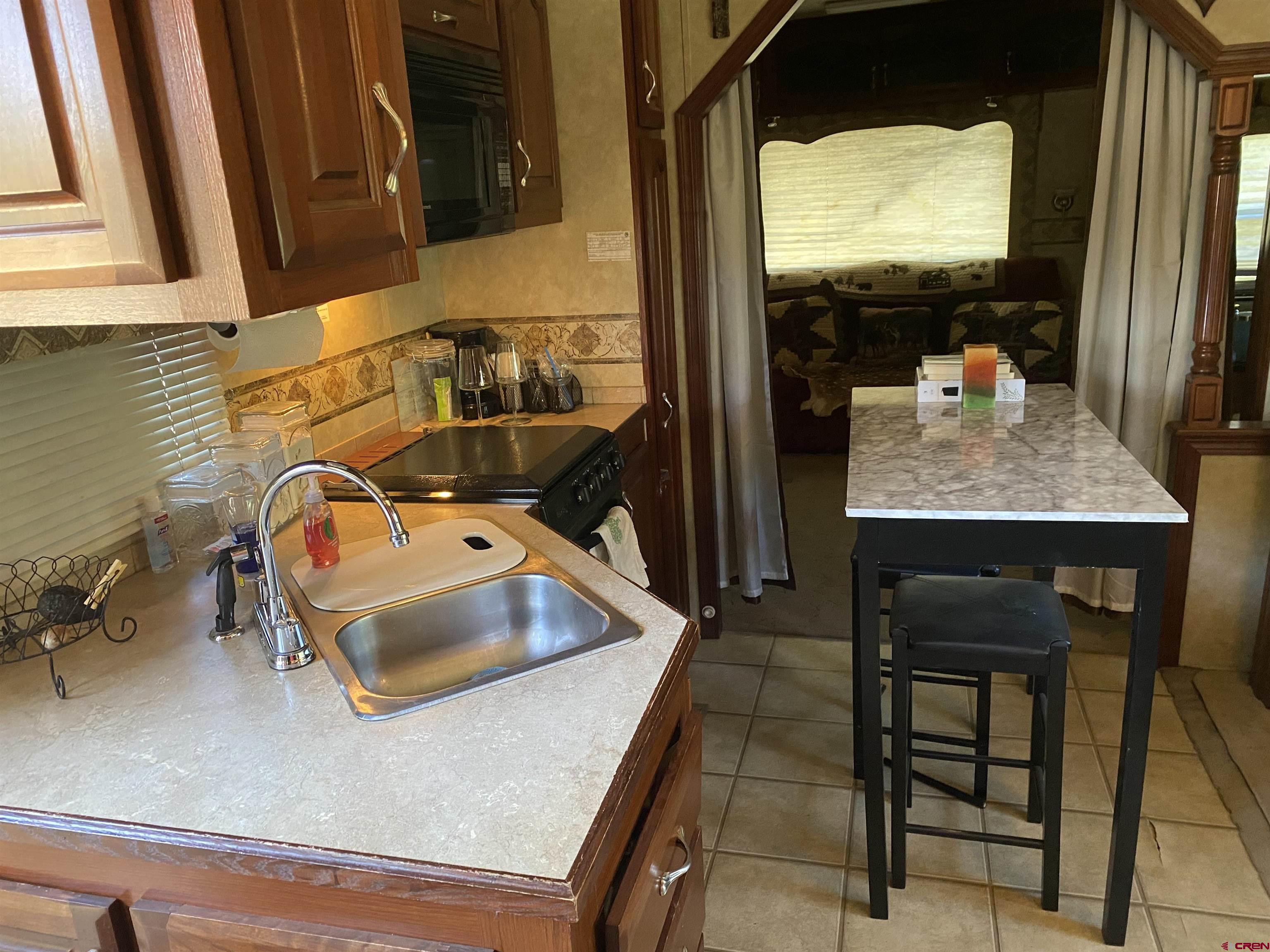 2444 Crooked Road Pagosa Springs, CO 81147 - Photo 11 of 22 a bathroom with a sink a mirror and next to a window