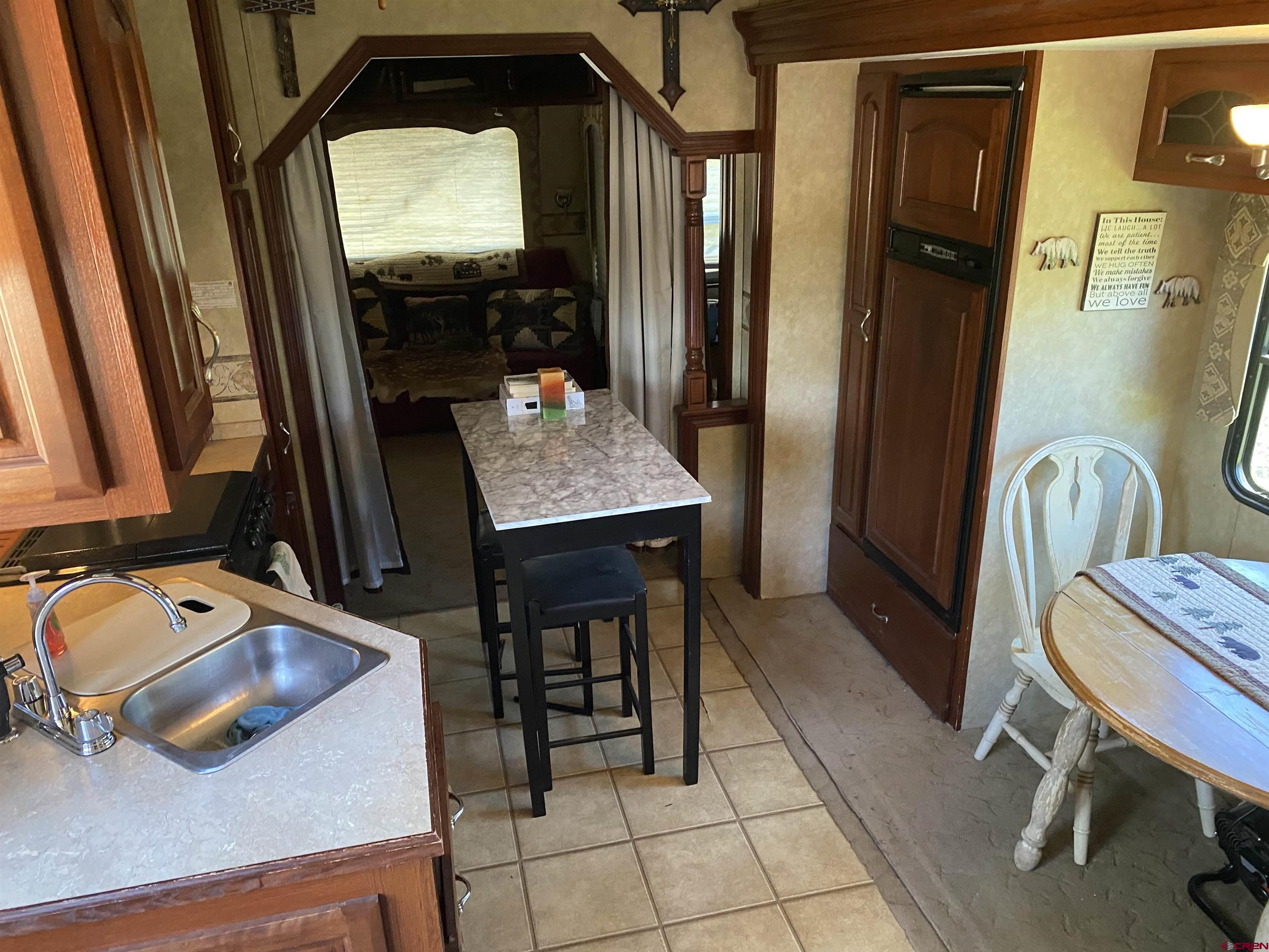 2444 Crooked Road Pagosa Springs, CO 81147 - Photo 16 of 22 a view of a hallway with furniture and front door