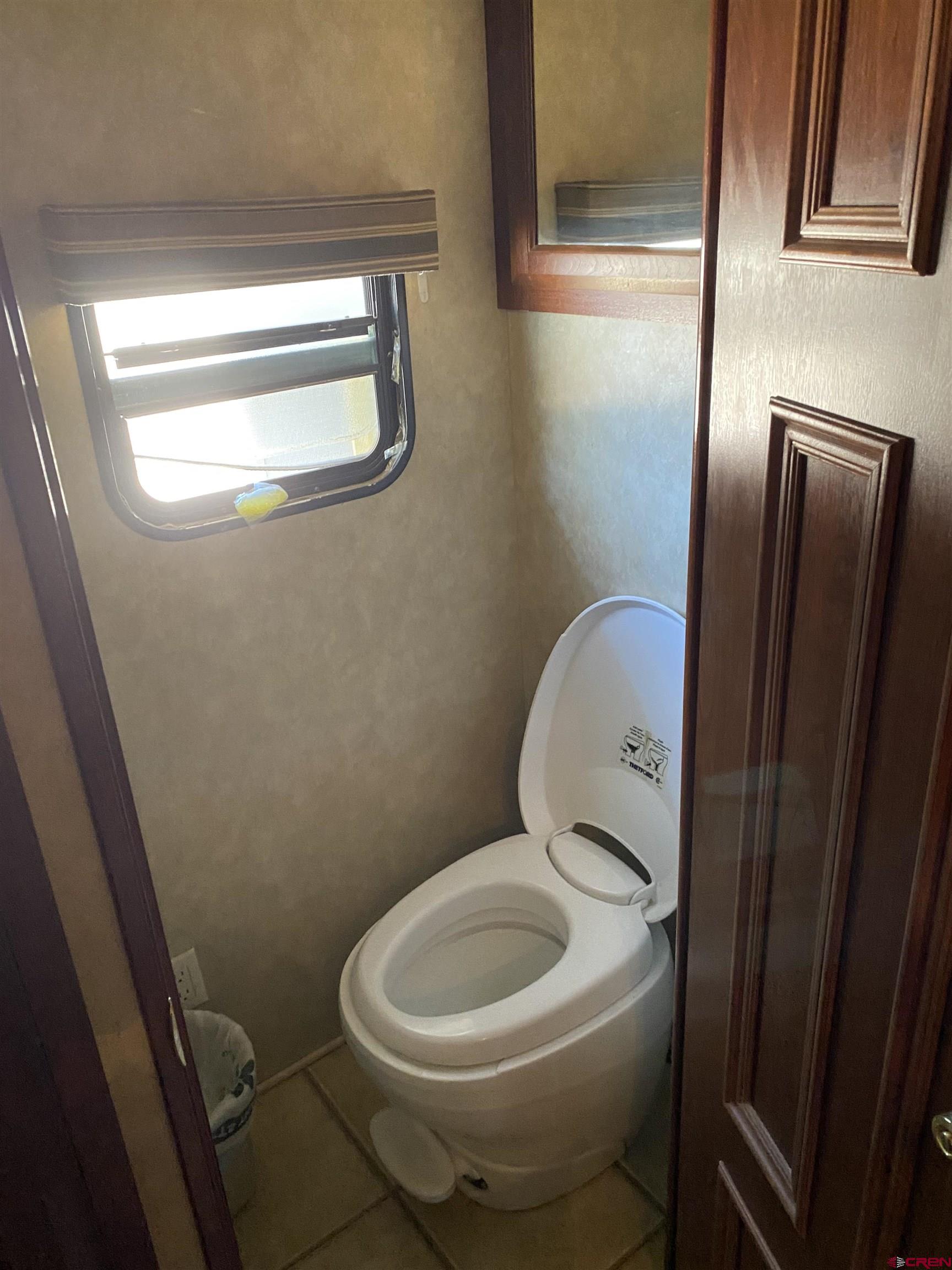 2444 Crooked Road Pagosa Springs, CO 81147 - Photo 20 of 22 a white toilet sitting next to a window