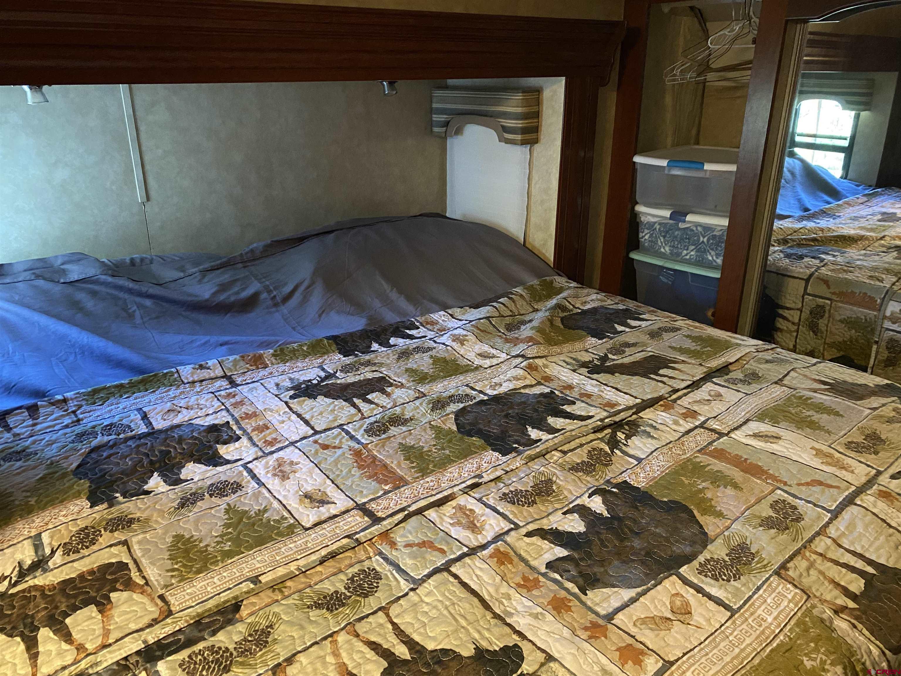 2444 Crooked Road Pagosa Springs, CO 81147 - Photo 21 of 22 a bedroom with a bed and a mirror