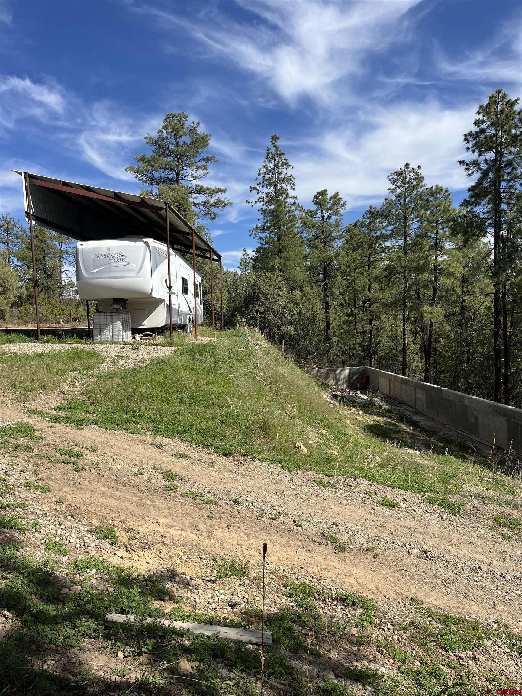 2444 Crooked Road Pagosa Springs, CO 81147 - Photo 22 of 22 a view of a house with a yard