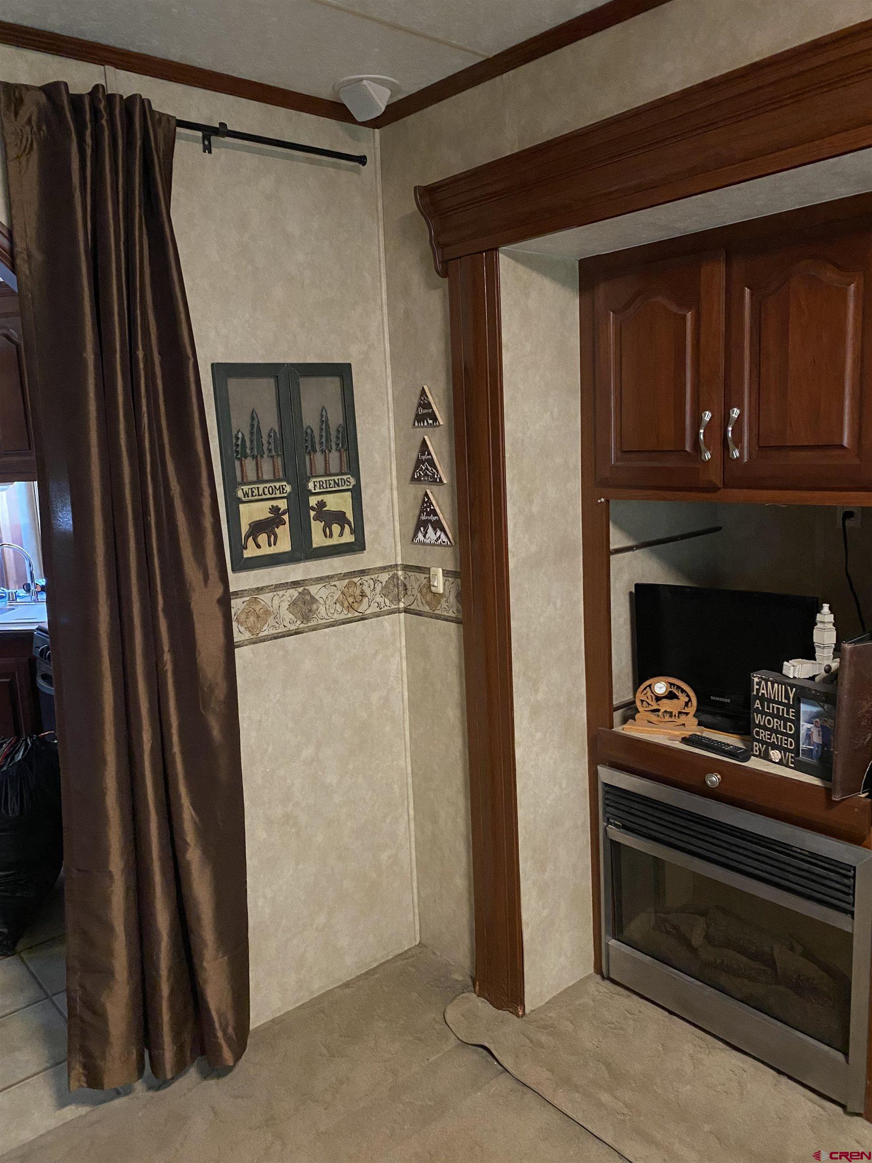 2444 Crooked Road Pagosa Springs, CO 81147 - Photo 4 of 22 a kitchen with a refrigerator and cabinets