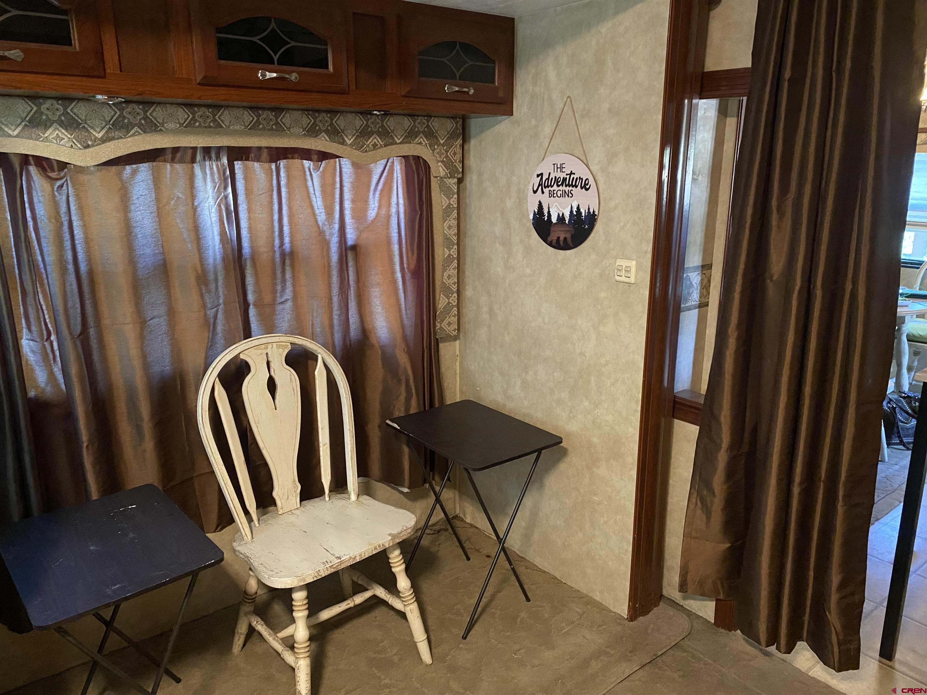 2444 Crooked Road Pagosa Springs, CO 81147 - Photo 7 of 22 a view of a hallway with chairs and a fan