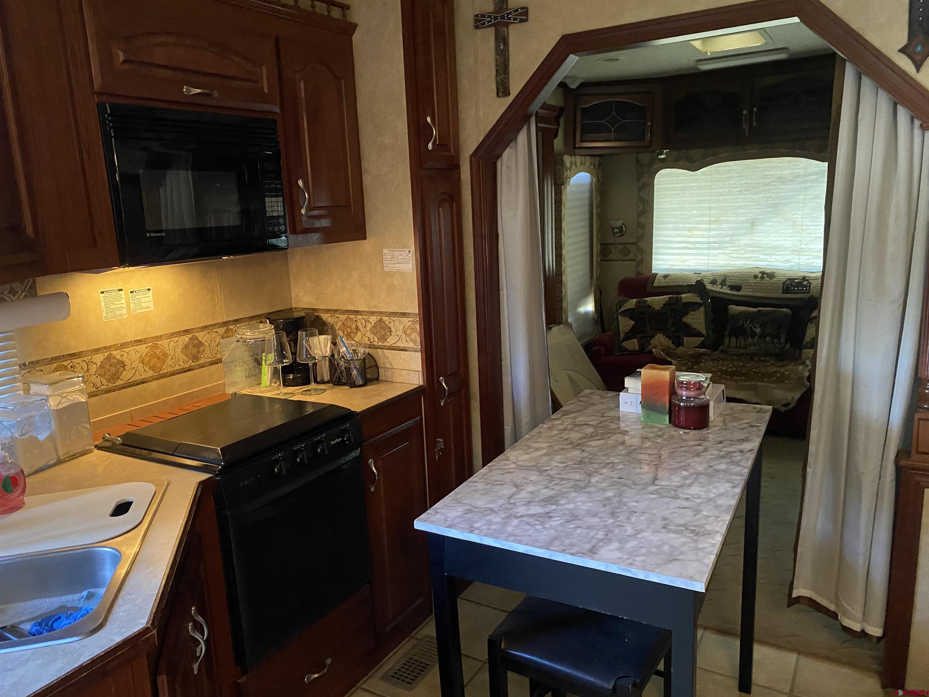 2444 Crooked Road Pagosa Springs, CO 81147 - Photo 8 of 22 a kitchen with a table chairs and a stove