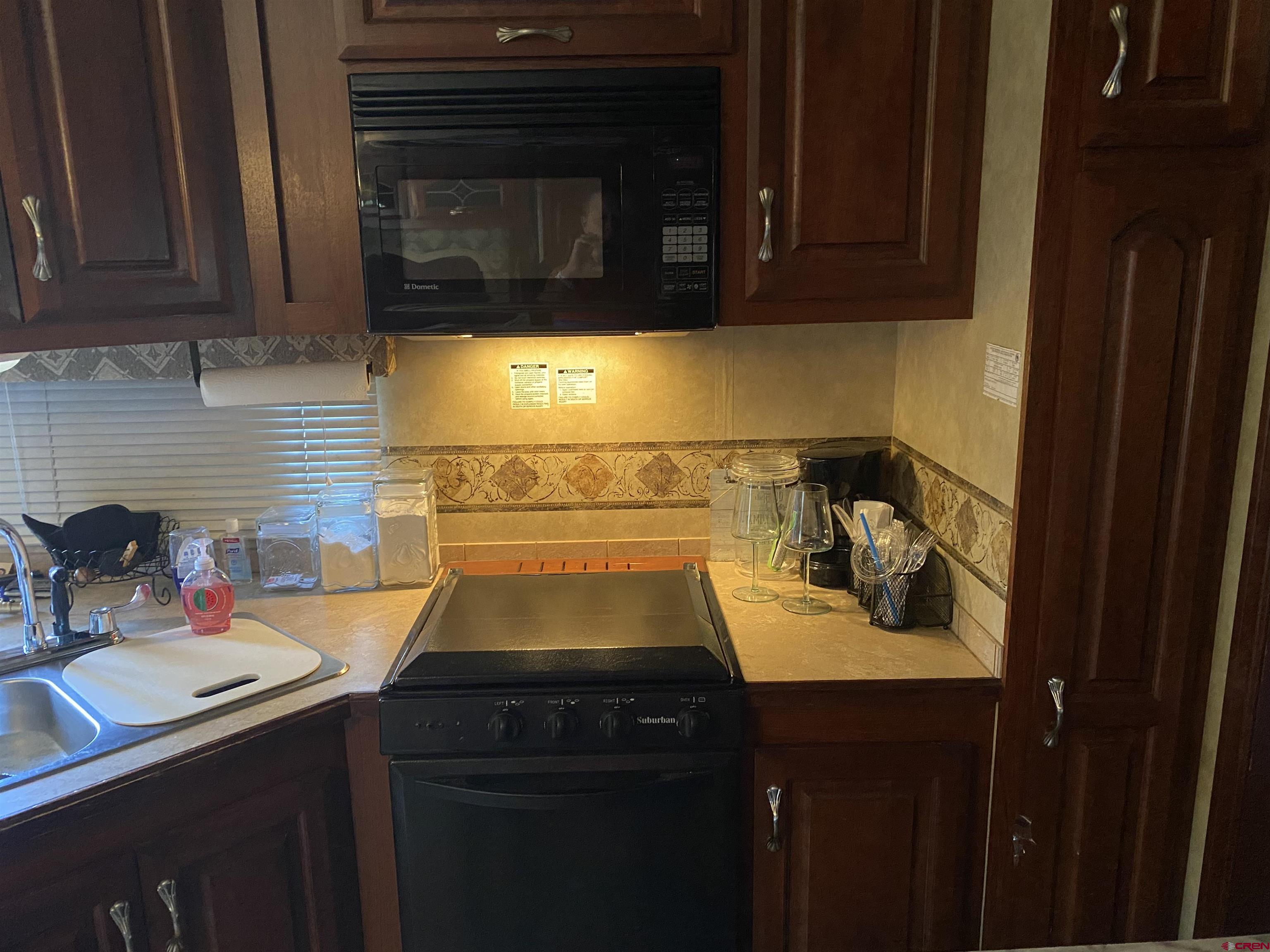 2444 Crooked Road Pagosa Springs, CO 81147 - Photo 9 of 22 a kitchen with a sink and cabinets