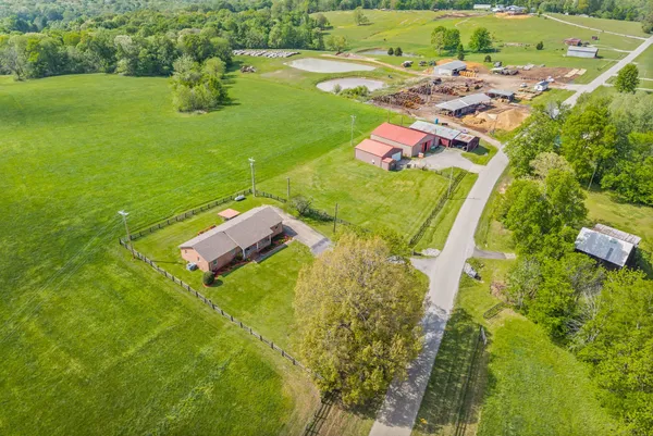 an aerial view of a house with a yard