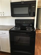 1400 Fairground Street, Unit C Taylor, TX 76574 - Photo 6 of 12 a stove top oven sitting inside of a kitchen