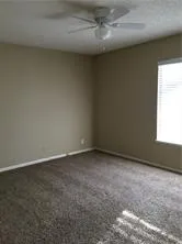 an empty room with a empty space and windows