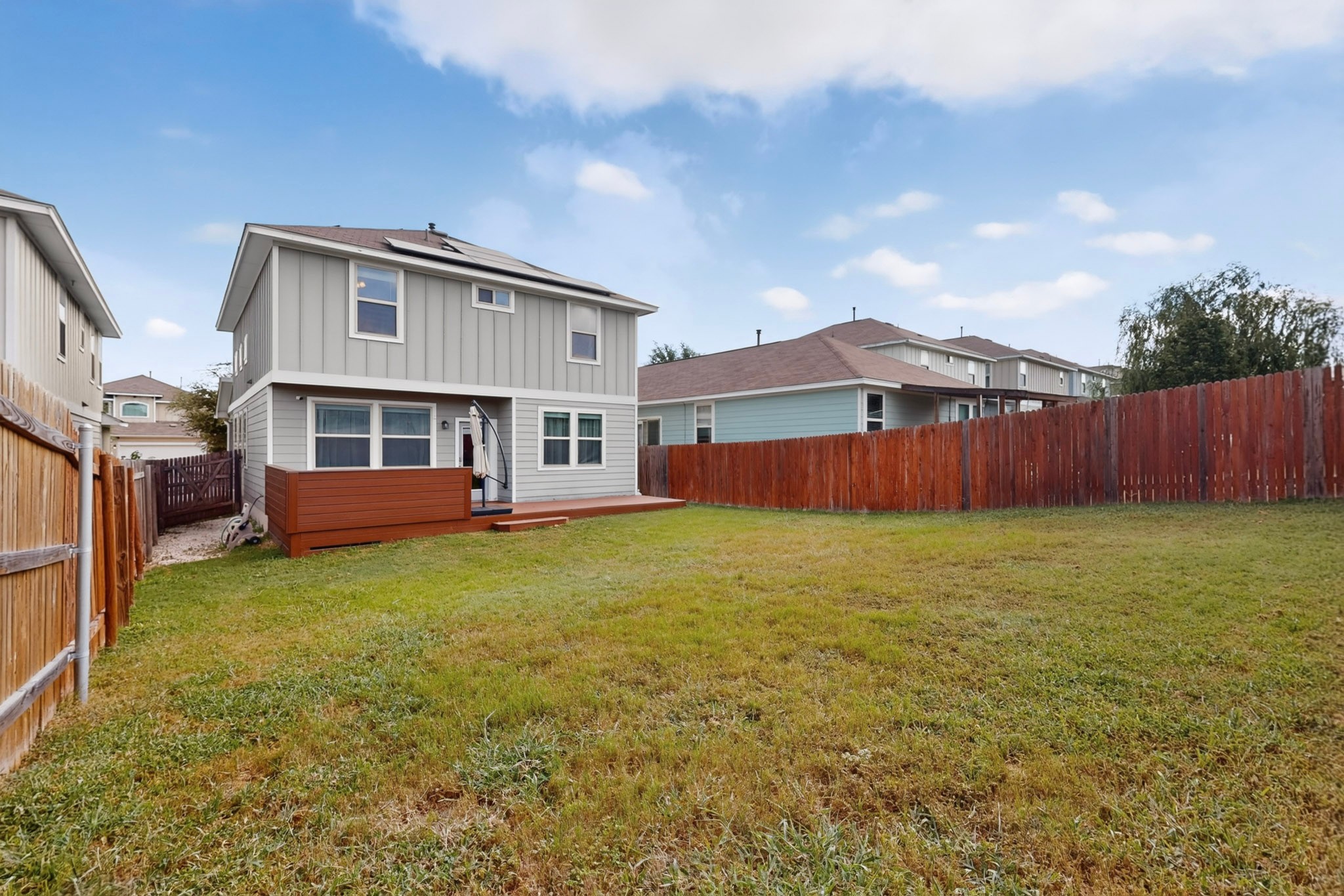 132 Wapiti Road Buda, TX 78610 - Photo 25 of 31 A spacious backyard with a private deck perfect for outdoor enjoyment and entertaining.
