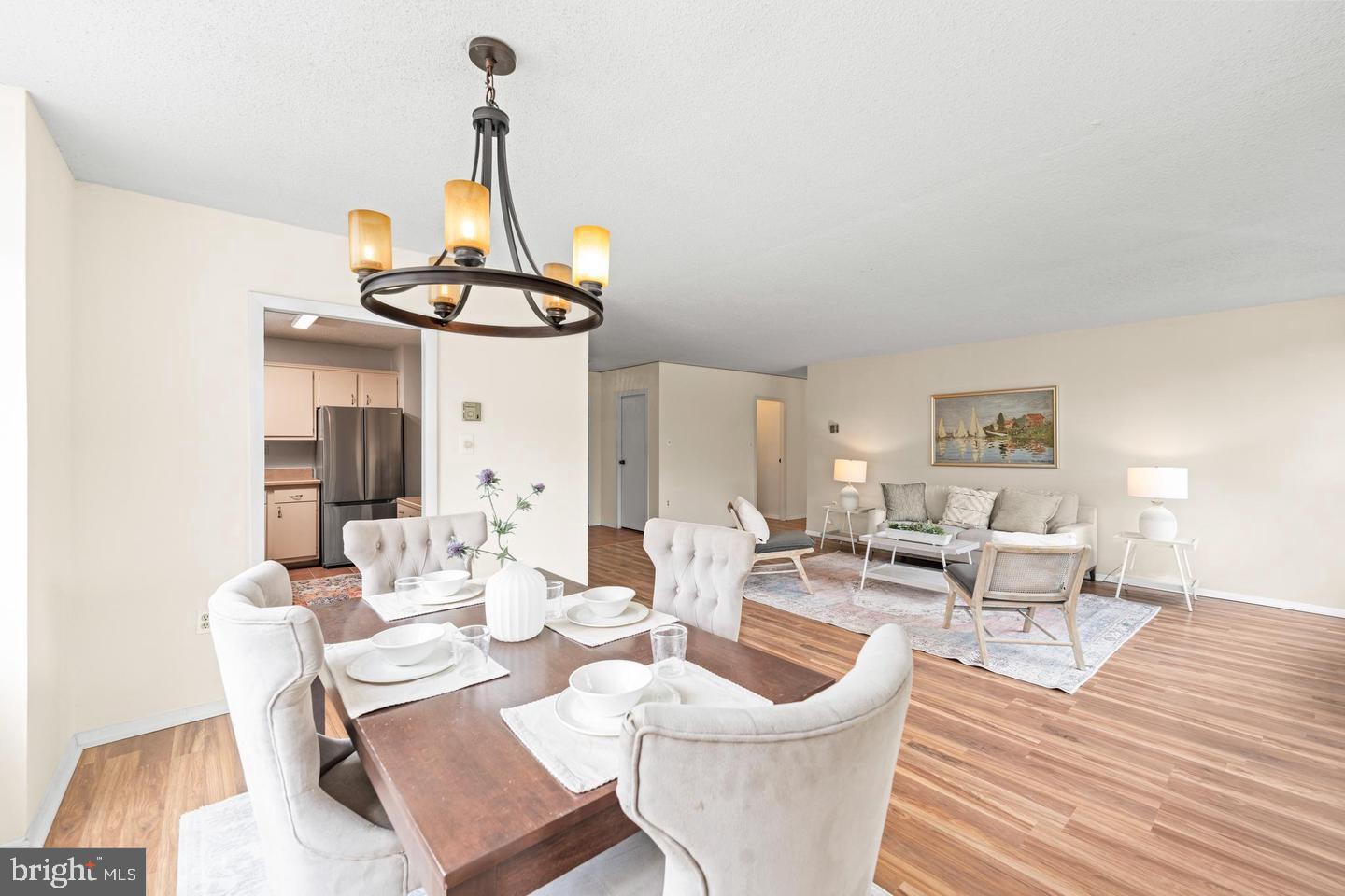4401 Roland Avenue, Unit 115 Baltimore, MD 21210 - Photo 12 of 25 a view of a dining room with furniture wooden floor and chandelier