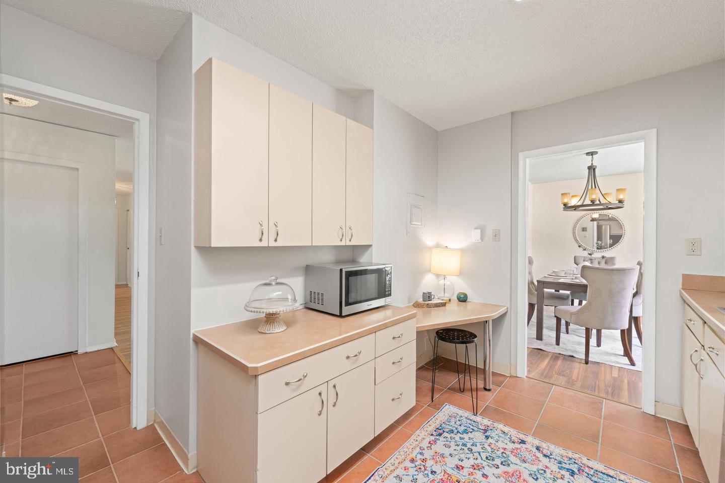 4401 Roland Avenue, Unit 115 Baltimore, MD 21210 - Photo 8 of 25 a kitchen with a stove and white cabinets