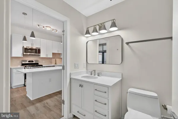 a bathroom with a toilet sink and mirror