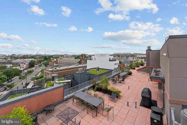 a view of a building with sitting area and furniture