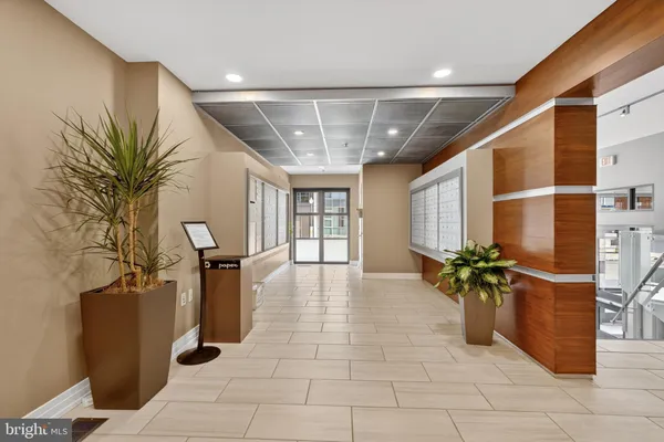 a lobby with furniture and potted plants