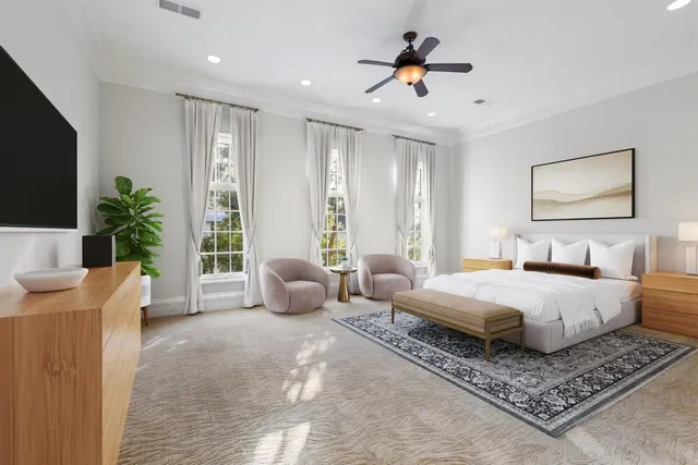 a spacious bedroom with a bed a couch and a potted plant