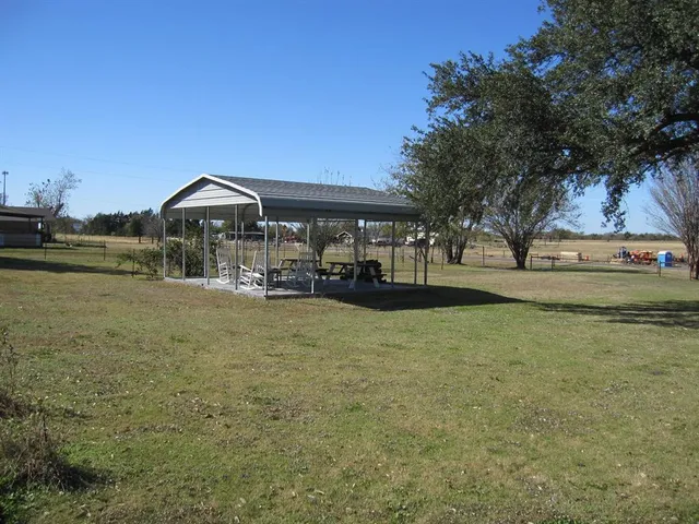 a view of a grassy field with trees