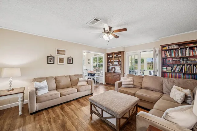 a living room with furniture and a book shelf