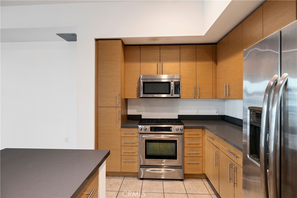 133 The Promenade North, Unit 426 Long Beach, CA 90802 - Photo 12 of 57 a kitchen with stainless steel appliances a stove a microwave and a refrigerator