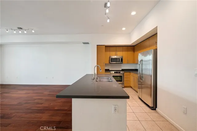 a view of a kitchen with wooden floor and a sink