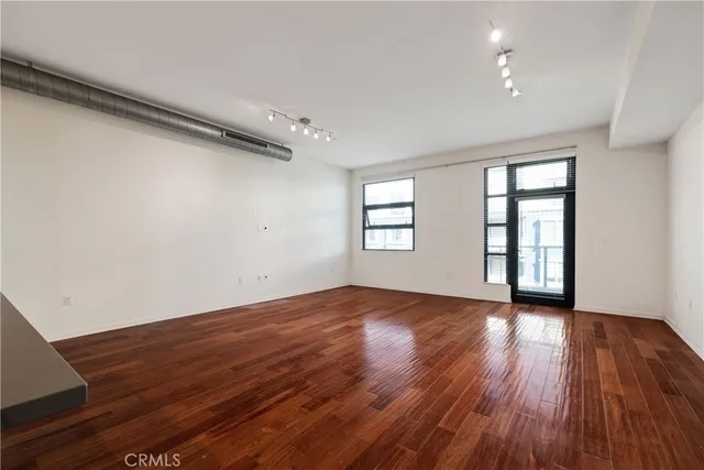 a view of a kitchen with wooden floor and a sink