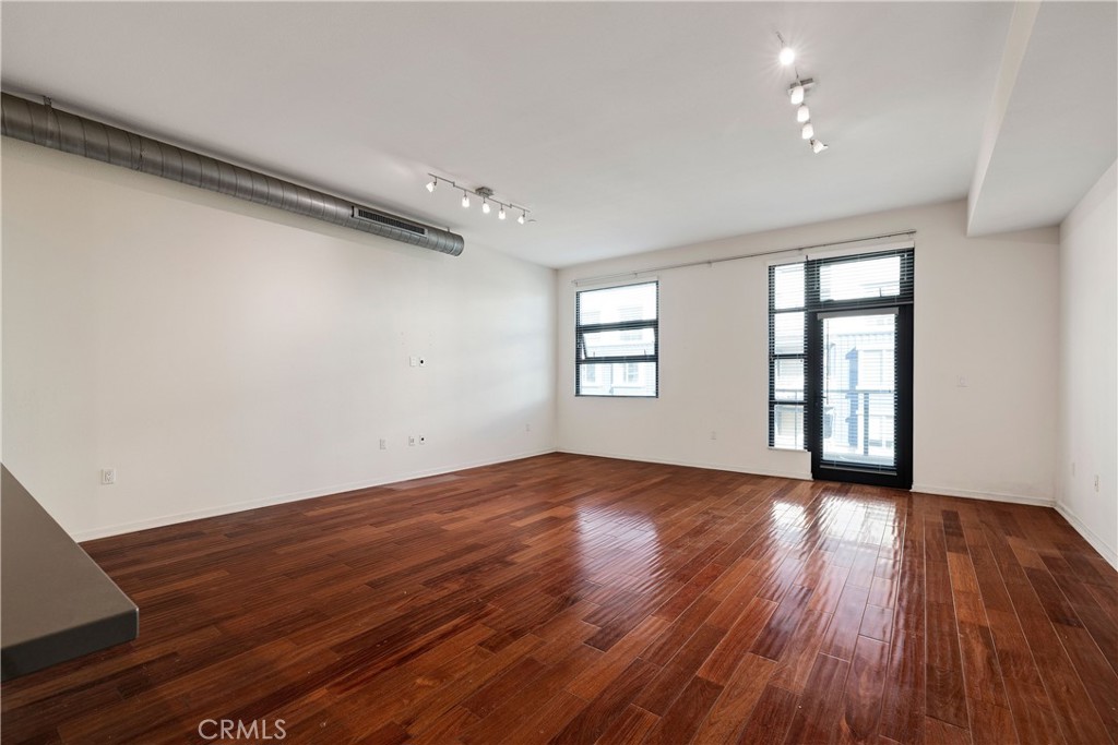 133 The Promenade North, Unit 426 Long Beach, CA 90802 - Photo 18 of 57 an empty room with wooden floor and windows