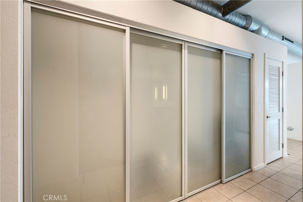 133 The Promenade North, Unit 426 Long Beach, CA 90802 - Photo 25 of 57 a bathroom with a glass shower door