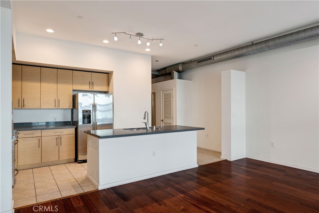 133 The Promenade North, Unit 426 Long Beach, CA 90802 - Photo 31 of 57 a kitchen with stainless steel appliances a sink and a refrigerator