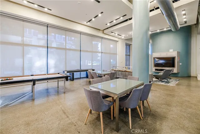 a kitchen with a stove a refrigerator and a view of living room