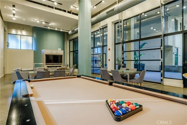 a dining room with furniture and a flat screen tv