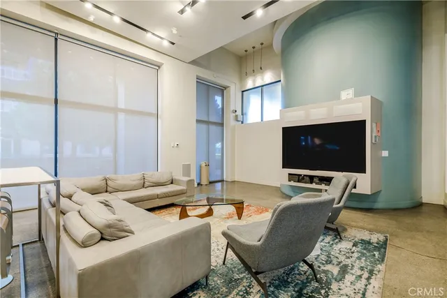 a room with lots of furniture and windows