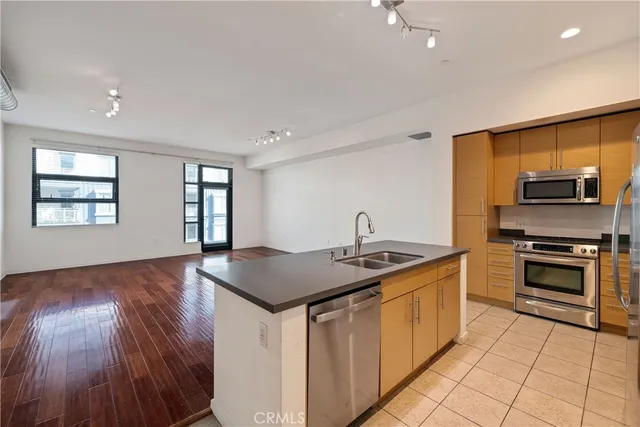 a kitchen with stainless steel appliances a stove a microwave and a refrigerator