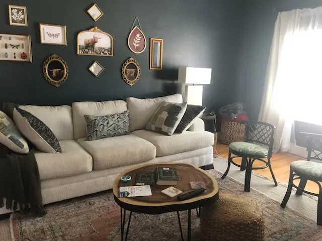 a living room with furniture and a lamp