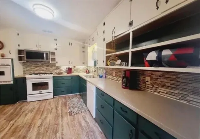 a kitchen with stainless steel appliances kitchen island granite countertop a stove and a sink