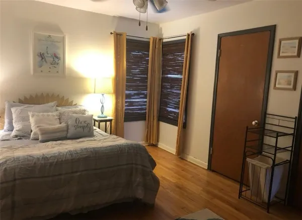a bedroom with a bed and wooden floor