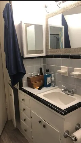 a bathroom with a sink and a mirror