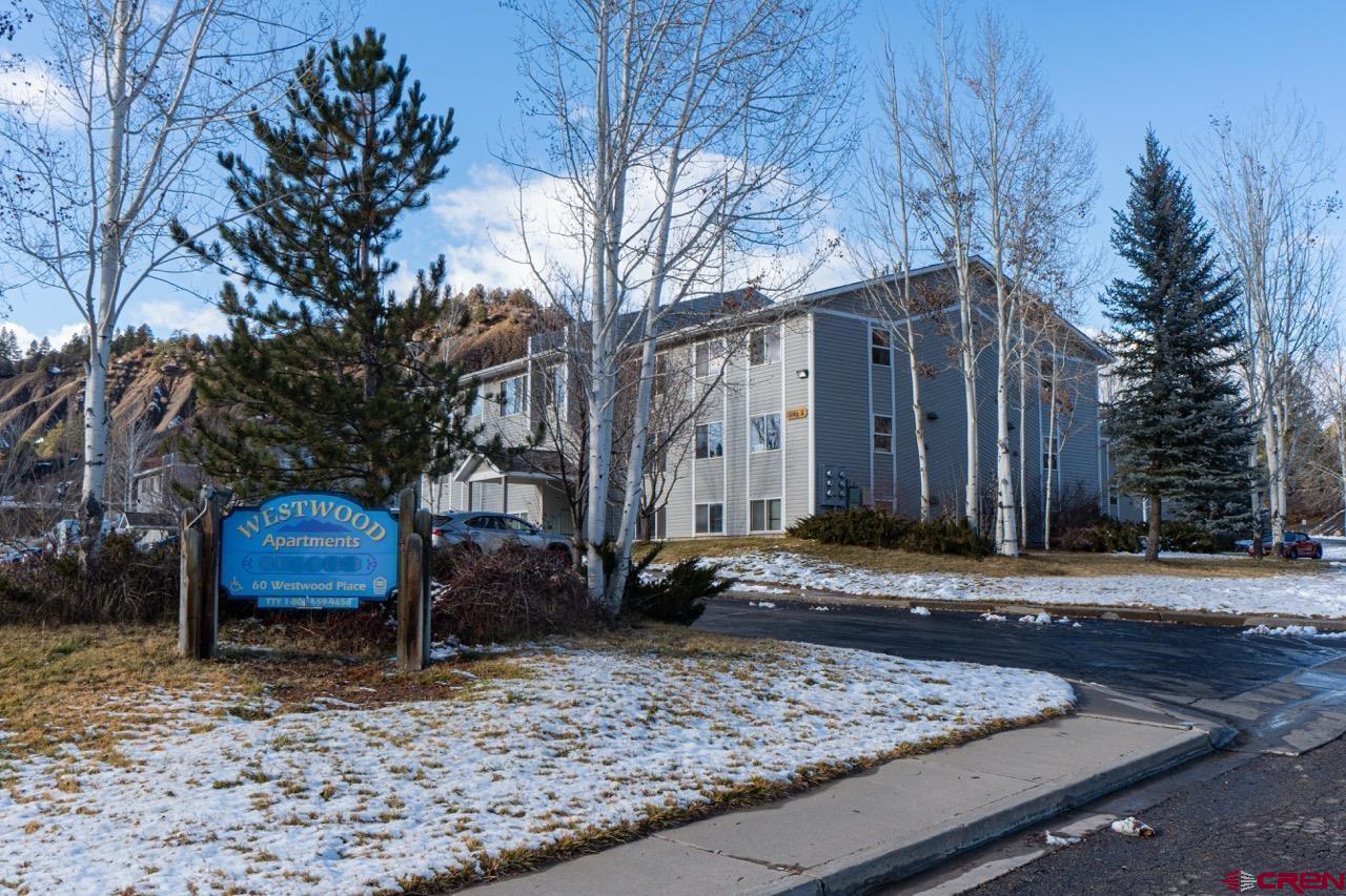 60 Westwood Place Durango, CO 81301 - Photo 16 of 16 a wooden bench sitting in front of a house