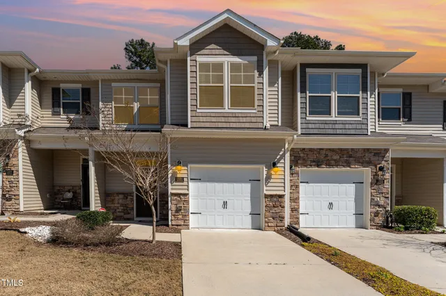 a front view of a house with a yard and garage