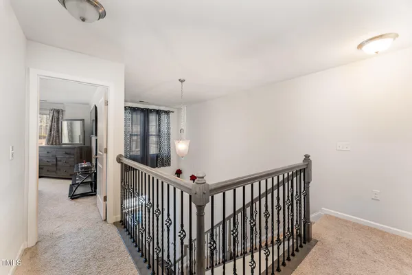 a view of a hallway with bedroom and closet