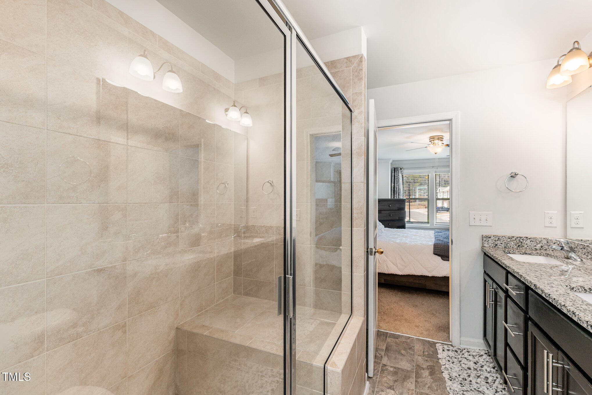 1101 Longitude Drive Durham, NC 27713 - Photo 18 of 26 a en suite bathroom with a granite countertop sink a mirror and shower