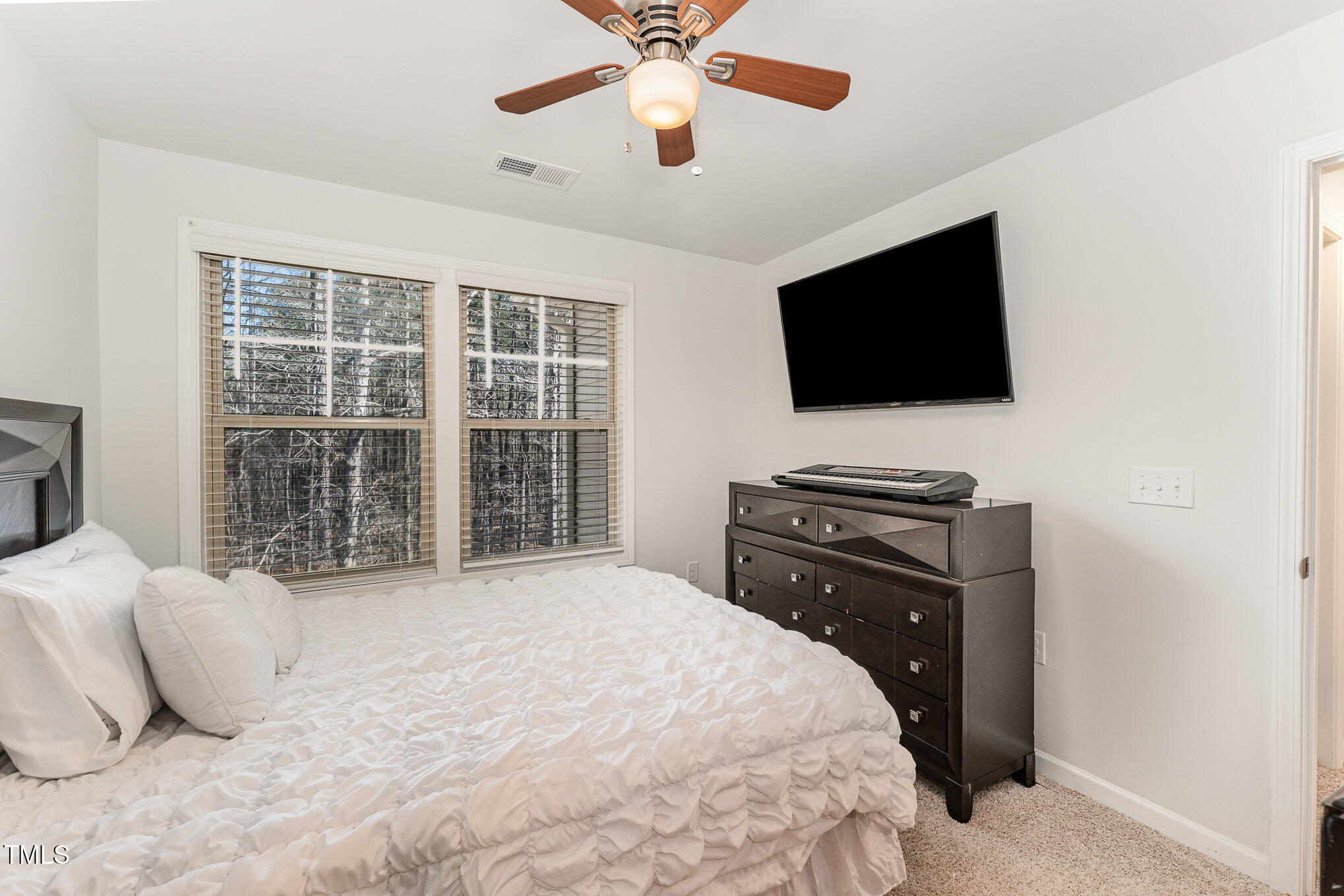1101 Longitude Drive Durham, NC 27713 - Photo 21 of 26 a bedroom with a bed and a flat screen tv