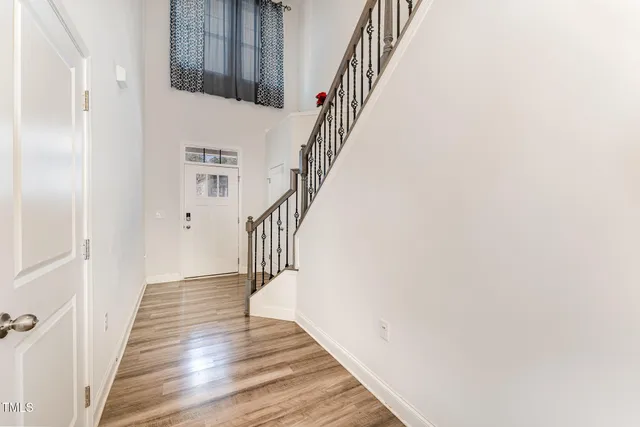 a view of entryway and hall with wooden floor