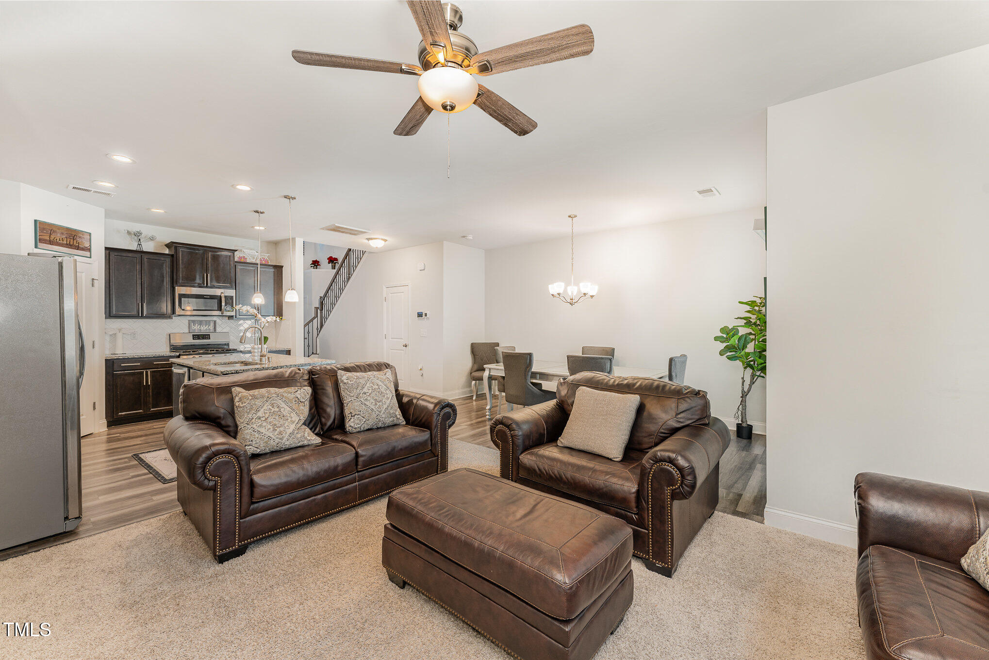 1101 Longitude Drive Durham, NC 27713 - Photo 7 of 26 a living room with furniture kitchen view and a chandelier