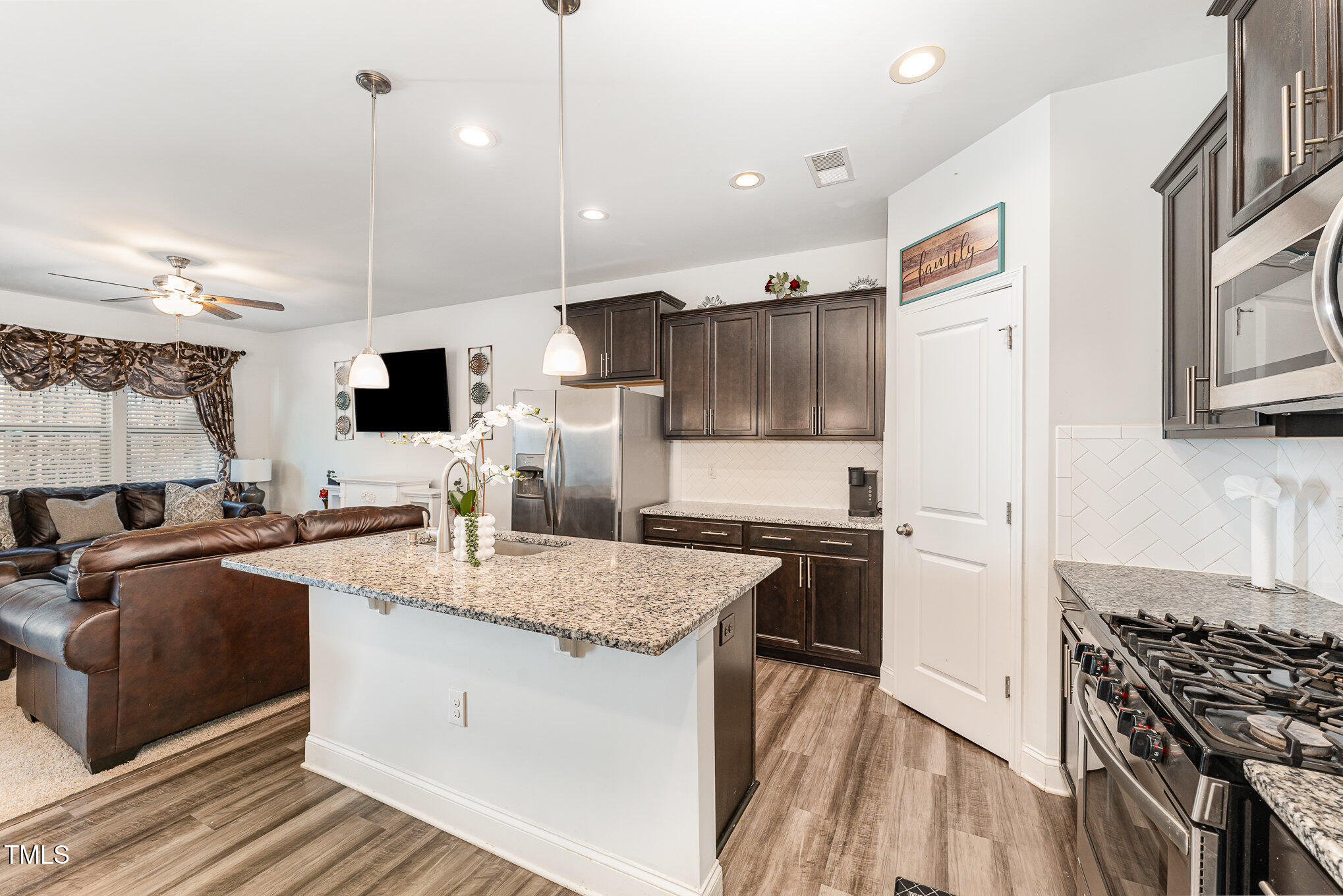 1101 Longitude Drive Durham, NC 27713 - Photo 9 of 26 a kitchen with granite countertop a sink stove and refrigerator