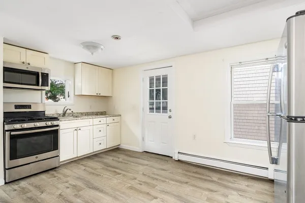 a kitchen with stainless steel appliances granite countertop a stove a sink and a refrigerator