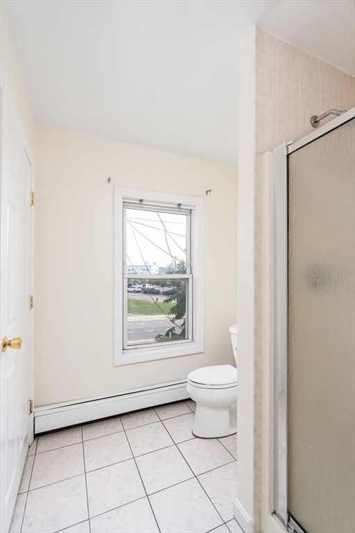 111 Washington Street, Unit 2 Somerville, MA 02145 - Photo 4 of 14 a bathroom with a toilet a window and a shower